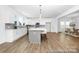 Modern kitchen with a large island and barstool seating, stainless appliances, and hardwood flooring at 233 Wheatfield Dr # 102P, Statesville, NC 28677
