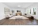 Spacious living room features lots of natural light, neutral color palette, and wood flooring at 233 Wheatfield Dr # 102P, Statesville, NC 28677