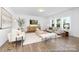Bright living room with large windows, hardwood floors, and modern neutral furnishings at 233 Wheatfield Dr # 102P, Statesville, NC 28677