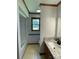 Bright bathroom showcasing a tub/shower combination and a window with a peaceful outdoor view at 2515 Myra Ln, Lincolnton, NC 28092