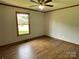 Bedroom featuring neutral walls, wood floors, a window, and baseboard trim at 2515 Myra Ln, Lincolnton, NC 28092
