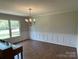 Light-filled dining room showcasing hardwood floors, panel molding, and an elegant chandelier at 2515 Myra Ln, Lincolnton, NC 28092