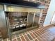 Close-up of a classic brick fireplace with a glass-door insert and a metal frame at 2515 Myra Ln, Lincolnton, NC 28092