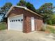 Exterior view of a brick garage with a white door and a concrete driveway at 2515 Myra Ln, Lincolnton, NC 28092