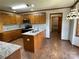 Well-lit kitchen features stainless appliances, wooden cabinetry, granite countertops, and wood flooring at 2515 Myra Ln, Lincolnton, NC 28092