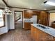 Kitchen boasts wooden cabinetry, granite countertops, stainless sink, and wood flooring at 2515 Myra Ln, Lincolnton, NC 28092