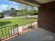 Inviting home showcasing a well-manicured front lawn and a mature tree viewed from the porch at 2515 Myra Ln, Lincolnton, NC 28092