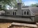 Inviting backyard featuring a wooden deck, brick chimney, and well-maintained landscaping, perfect for outdoor living at 27 Quayside Ct, Clover, SC 29710