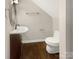 Small bathroom with hardwood floors, a wall mounted sink, a dark wood vanity, and a sleek elongated toilet at 27 Quayside Ct, Clover, SC 29710