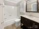 Bathroom featuring a vanity with a dark wood base, tile flooring, and a shower/tub combo at 27 Quayside Ct, Clover, SC 29710