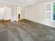 Bedroom with plush carpeting, white trim, and a window providing natural light at 27 Quayside Ct, Clover, SC 29710