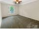 Bright bedroom with a ceiling fan, neutral carpet and a window with shutters at 27 Quayside Ct, Clover, SC 29710