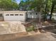 Charming one-story home featuring a detached garage, walkway, and inviting front yard, nestled amongst mature trees at 27 Quayside Ct, Clover, SC 29710