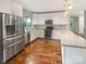 Modern kitchen featuring white cabinets, stainless steel appliances, granite countertops, and hardwood floors at 27 Quayside Ct, Clover, SC 29710