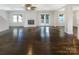 Spacious living room with beautiful hardwood floors, fireplace, windows, and patio door, creating a bright and airy space at 27 Quayside Ct, Clover, SC 29710