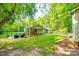 Secluded backyard featuring mature trees, patio seating, fencing, and outdoor grill; perfect for entertaining at 2984 Starnes Dr, Rock Hill, SC 29730