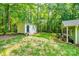 This backyard features mature trees, a shed, a wooden playset, and a covered outdoor cooking area with seating at 2984 Starnes Dr, Rock Hill, SC 29730