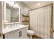 Compact bathroom with a white vanity, framed mirror, and a shower with a patterned curtain and open wood shelves at 2984 Starnes Dr, Rock Hill, SC 29730