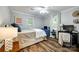 Cozy bedroom with hardwood floors, neutral walls, and a brightly colored dresser at 2984 Starnes Dr, Rock Hill, SC 29730