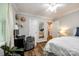 This light-filled bedroom includes wood flooring, a workstation, and a mirror providing views into the en-suite bathroom at 2984 Starnes Dr, Rock Hill, SC 29730