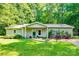 Charming single-story home featuring a well-manicured lawn, inviting front porch, and lush landscaping at 2984 Starnes Dr, Rock Hill, SC 29730