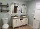 Bathroom with double sink vanity, stylish lighting and tile flooring at 3210 Crow Row, Monroe, NC 28112