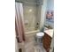Bathroom with shower and tub combination, vanity sink, neutral ceramic tile floors, and colorful cow painting at 3210 Crow Row, Monroe, NC 28112
