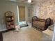 Charming Bedroom with floral wallpaper, a crib and whimsical decor at 3210 Crow Row, Monroe, NC 28112
