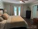 Well lit bedroom with ceiling fan, dark wood floors and access to a deck at 3210 Crow Row, Monroe, NC 28112
