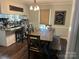 Eat-in kitchen featuring a rustic wood table and chairs, open to a breakfast bar with seating at 3210 Crow Row, Monroe, NC 28112