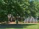 Charming home exterior with a front porch and beautifully landscaped front yard on a sunny day at 3210 Crow Row, Monroe, NC 28112