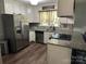 Bright kitchen with stainless steel appliances, granite countertops, and modern tile backsplash at 3210 Crow Row, Monroe, NC 28112