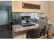 Updated kitchen features granite counters, a mosaic tile backsplash, stainless appliances, and a breakfast bar at 3210 Crow Row, Monroe, NC 28112