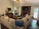 Inviting living room featuring a large sofa, brick fireplace, and stylish decor at 3210 Crow Row, Monroe, NC 28112
