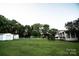Expansive backyard features two sheds, an inground pool, and a lush green lawn at 34107 Watson Rd, Albemarle, NC 28001