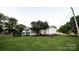 Spacious backyard featuring a screen porch, lush lawn, and mature trees at 34107 Watson Rd, Albemarle, NC 28001