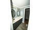 Stylish bathroom with a vanity, round mirrors and wood flooring, providing a modern aesthetic at 34107 Watson Rd, Albemarle, NC 28001
