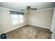 Cozy bedroom with plush carpeting and a ceiling fan, offering a comfortable retreat at 34107 Watson Rd, Albemarle, NC 28001