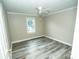 Bright bedroom featuring neutral paint, durable flooring, a ceiling fan, and a window at 34107 Watson Rd, Albemarle, NC 28001