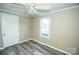 Comfortable bedroom with a ceiling fan, window, neutral walls, and durable flooring at 34107 Watson Rd, Albemarle, NC 28001