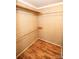 Walk in closet with modern shelving and wooden floors provides ample space and organization at 34107 Watson Rd, Albemarle, NC 28001