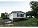 Single story home with white siding, blue shutters, and a two-car garage at 34107 Watson Rd, Albemarle, NC 28001