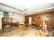 Spacious garage featuring wood paneled walls, offering ample space for storage and organization at 34107 Watson Rd, Albemarle, NC 28001