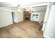 Spacious living room featuring a stone fireplace and sliding door access to the porch at 34107 Watson Rd, Albemarle, NC 28001