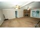 Spacious living room featuring a stone fireplace and sliding door access to the porch at 34107 Watson Rd, Albemarle, NC 28001