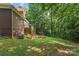 A shot of the home's backyard, complete with a wooden deck, mature trees, and a fire pit area at 3916 2Nd Street Nw Dr, Hickory, NC 28601