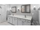 Stylish bathroom with double sink vanity, decorative mirrors, and modern fixtures at 3916 2Nd Street Nw Dr, Hickory, NC 28601