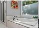 Relax in this bathroom's luxurious soaking tub with a large window and black hardware throughout at 3916 2Nd Street Nw Dr, Hickory, NC 28601