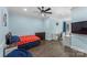 Comfortable bedroom featuring hardwood floors, ceiling fan, and dedicated workspace at 3916 2Nd Street Nw Dr, Hickory, NC 28601