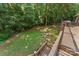 A look from the deck into the private backyard with mature trees and a custom fire pit area at 3916 2Nd Street Nw Dr, Hickory, NC 28601